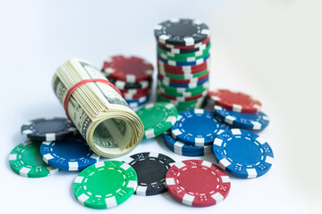 Poker chips, dollars on white background
