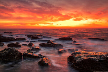 Fototapeta na wymiar Stunning fire sunrise over the sea. Horizontal view
