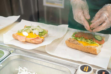 Close up of Hand Preparing Sandwich
