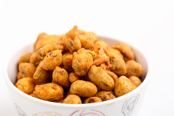 Roasted coated peanuts on white background. Delicious snack peanut.