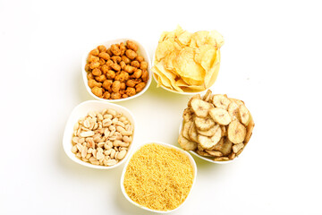 Indian snack peanuts,chips,kurkure,sev in bowl on white background.