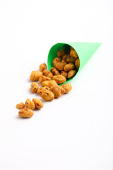 Roasted coated peanuts on white background. Delicious snack peanut.