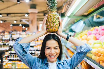 Portrait funny cheerful young woman shopping at supermarket