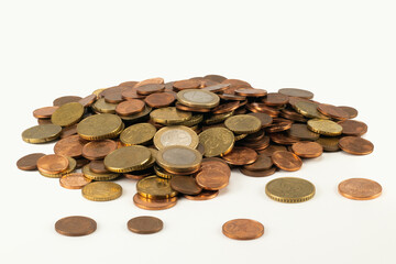 Pile of money coins isolated on bright background. Close up view.