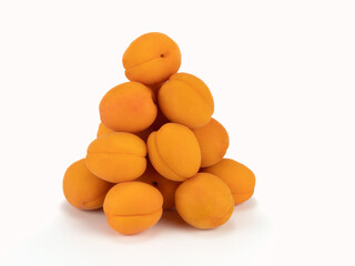 Pile of fresh apricot fruit isolated on bright background. Healthy fresh food fruits concept. Close up view.