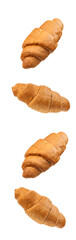 Croissants brioche bun flies in the air. Freshly baked puff pastry cookies fall on white. Delicious...
