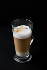 Coffee with milk on dark background. Close up. Copy space.