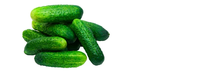 Papier Peint photo Lavable Légumes frais green cucumbers on a white background. ripe gherkins on a table. fresh vegetables on a light texture. the concept of growing cucumbers