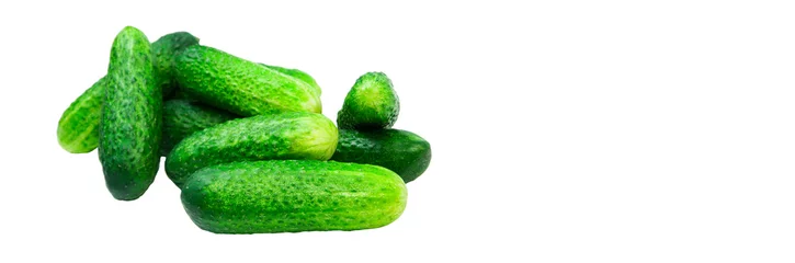 Photo sur Aluminium Légumes frais green cucumbers on a white background. ripe gherkins on a table. fresh vegetables on a light texture. the concept of growing cucumbers