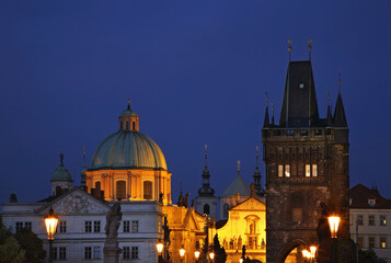 Fototapeta na wymiar Church of Saint Francis of Assisi and Tower at Staro Mesto end of Charles Bridge in Prague. Czech Republic