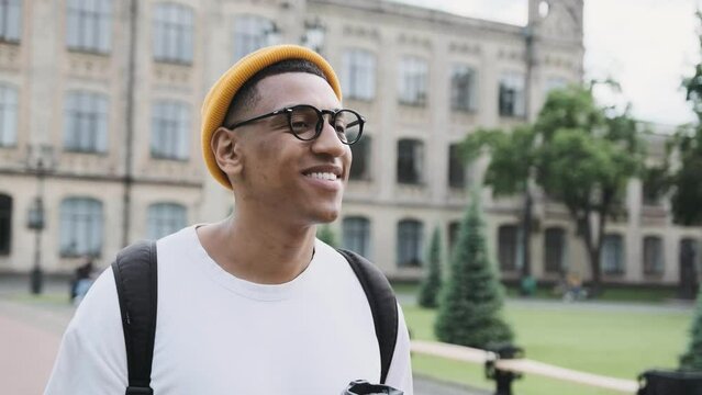 Portrait of a stylish mulat smiling young man, walking outdoors.