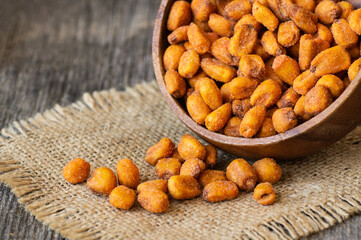 Roasted salted Corn Nuts with Spice and Sauce in bowl on wooden background, Nut concept