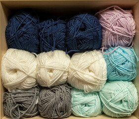 Close Up of yarn balls. Rainbow colors. Yarn for knitting. Skeins of yarn. Knitting needles, colorful threads. Knitting background, Knitting yarn for handmade winter clothes.