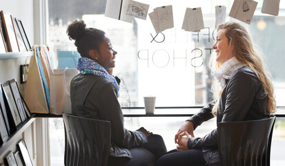 Enjoying a cup of coffee together. Two young women buying coffee together.
