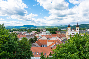 Obraz premium View of city Trencin, Slovakia. Beautiful town square with panoramic view to ancient Castle on the hill. Summer day with blue sky.