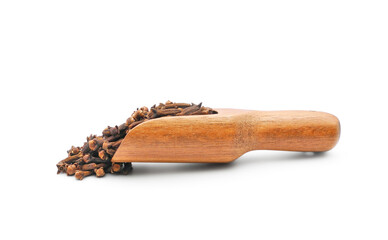 Aromatic dry cloves closeup in wooden measuring scoop side view isolated on white background 