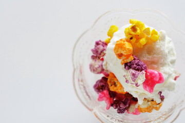 Multiple color popcorn on vanilla ice-cream