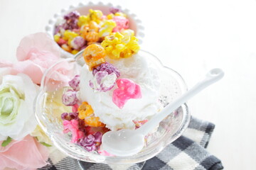 Multiple color popcorn on vanilla ice-cream