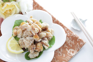 Chinese food, deep fried chicken soft bon on white dish served with lemon