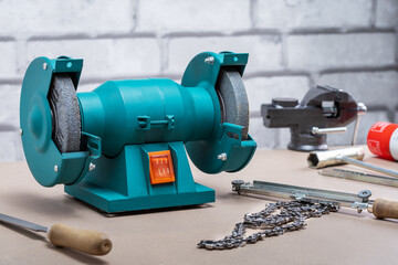 Electric sharpener and different tools in workshop. Concept of small business.