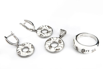 Silver jewelry set of ring and silver earrings with stones on white background. Silver jewelry set collection