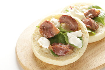 Canned food, smoked chicken gizzard and cream cheese in English muffin sandwich