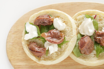 Canned food, smoked chicken gizzard and cream cheese in English muffin sandwich