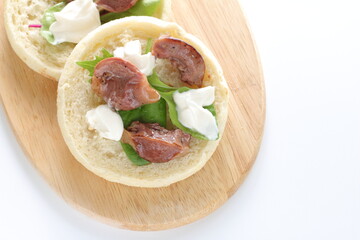 Canned food, smoked chicken gizzard and cream cheese in English muffin sandwich