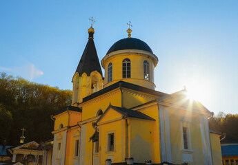 Church with sunlight . Sun rays over domes