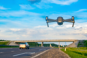 quadcopter with a video surveillance camera hovered on the highway for monitoring, speed control and violations on the road