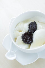 Dried plum and honey on Yogurt for healthy dessert and breakfast