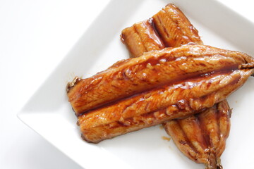 Japanese food, sweet soy sauce and grilled pacific saury Santa fish on white plate