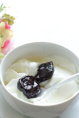 Dried plum and honey on Yogurt for healthy dessert and breakfast