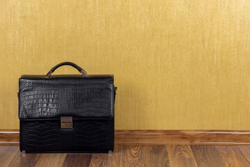 A business briefcase stands against the background of a wall. Financial crisis. Business concept.