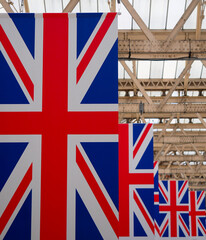 Fototapeta na wymiar A colourful line of Union Jack flags hanging from a roof in London UK