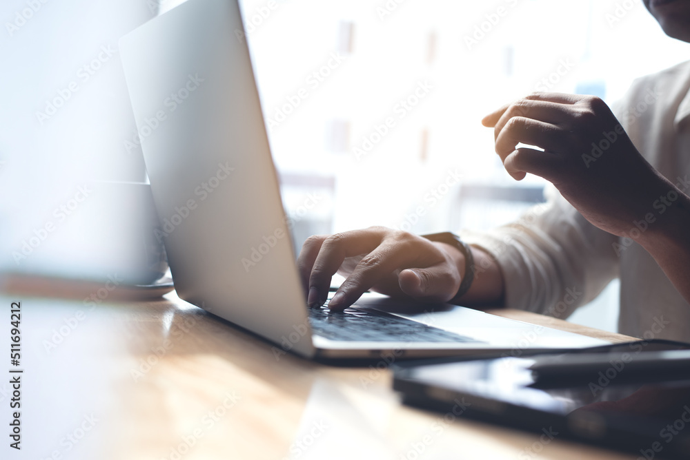 Wall mural business man busy working on laptop computer with digital tablet on office table. blogger typing on 