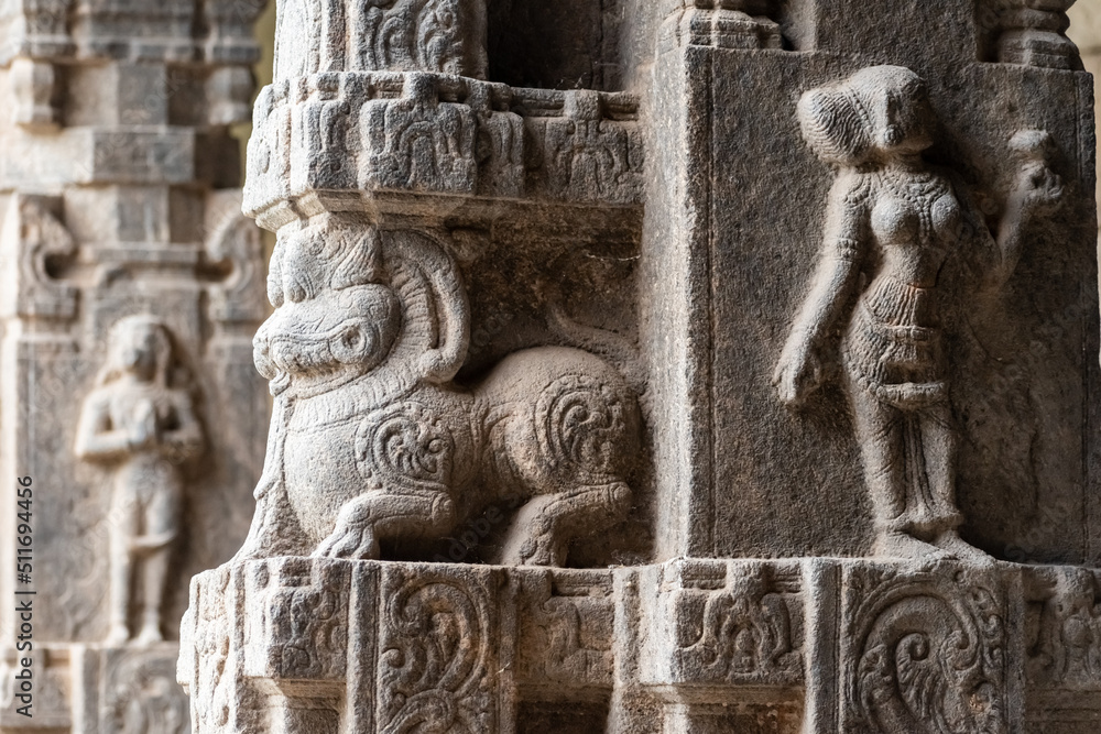 Wall mural a beautiful stone carving of a figurine on the stone columns of the ancient hindu temple of jalakand