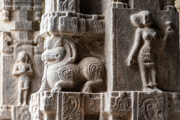 A beautiful stone carving of a figurine on the stone columns of the ancient Hindu temple of...