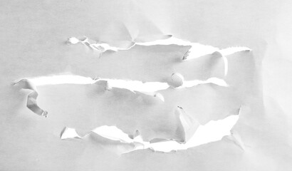 Scratched white paper with holes, isolated
