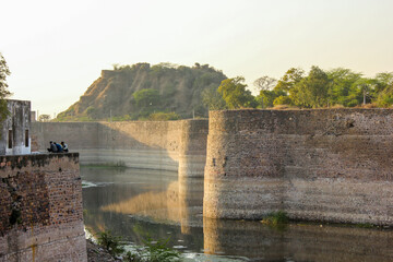 Fototapeta premium The ancient Lohagarh fort with the bridge across the river moat in the town of Bharatpur.