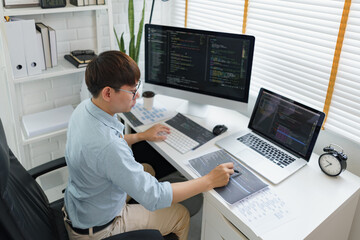 Obraz na płótnie Canvas Software development concept, Male programmer pointing on data code to checking website programming