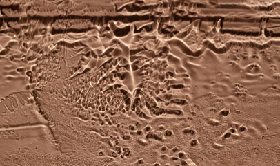 Water drops, streaks on the glass on a coral background