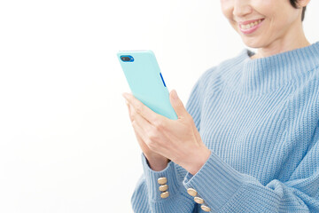 スマホを使う中年女性の手元　白背景