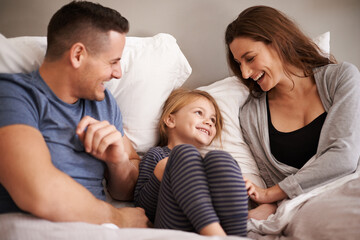 In bed with mom and dad. Cropped shot of an affectionate young family lying in bed together.