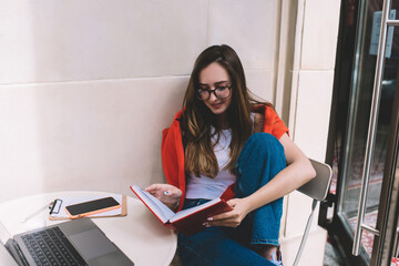 Caucasian female learning with online course on laptop computer. Young woman freelance enjoying distance work on netbook. Educational webinar.