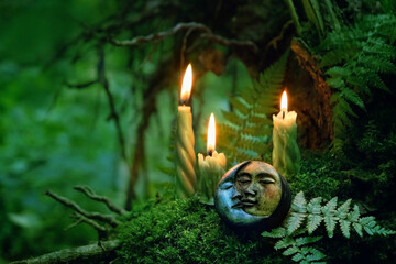 candles and symbolic moon amulet on dark forest background. pagan Wiccan, Slavic traditions for Litha. Witchcraft, esoteric spiritual ritual, magic practice. Mysticism, divination, modern occultism - obrazy, fototapety, plakaty