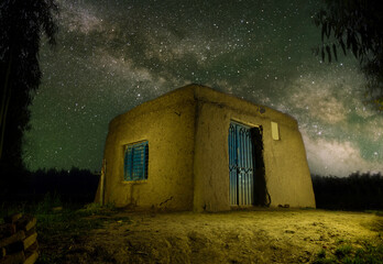 Vintage hut inside jungle with light painting around.