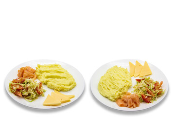 Tasty breakfast or lunch with potato puree with fresh salad with cabbage and tomatoes, cucumber and red fish - salmon, and pieces of cheese on the white plate. Two plates with meal