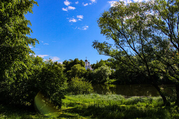 The temple seen in the distance among the beautiful summer nature