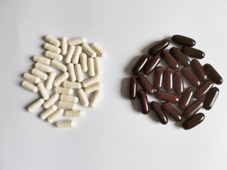 white and black pills on white background
